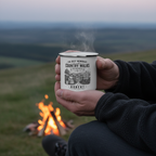 UGC lifestyle photo of man by campfire cradling personalised enamel camping mug with Robert name — Country Walks design, warm orange firelight glow at dusk, steam rising from mug
