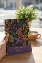 A5 lined spiral notebook showing colorful leaf artwork on dark cover