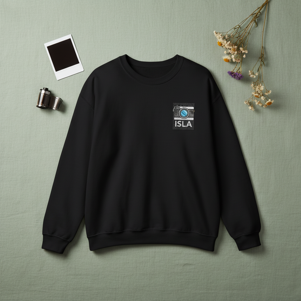 Black sweatshirt with embroidered camera patch and ISLA name
