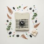 Cream pullover hoodie with 'It's my birthday' text and smiley face graphic