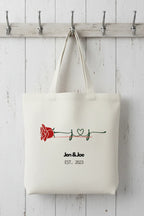Cream tote bag with red rose and 'Jen & Joe' EST. 2023 print
