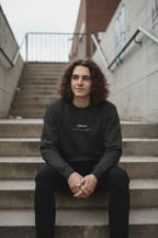 Black crewneck sweatshirt with centered planet logo text and heart