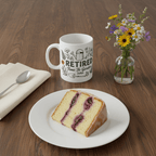 White retired garden mug with 'RETIRED' and floral watering-can design, John