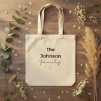 Natural canvas tote bag with handles and “The Johnson family” text and heart