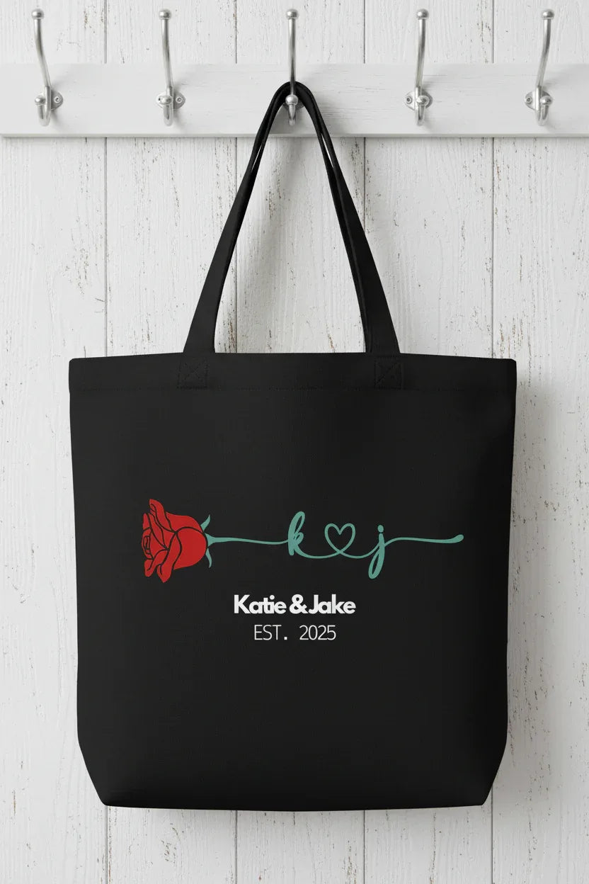 Black tote bag with red rose and 'Katie & Jake' EST. 2025 front print