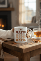 Personalised white mug with stacked “KATIE” text and a small heart above the word.
