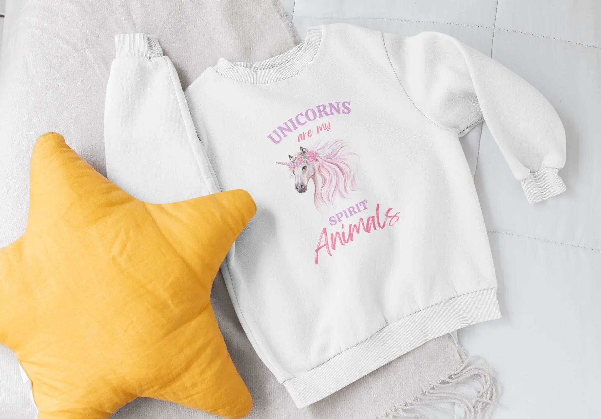 Kids white sweatshirt with unicorn and "Spirit Animals" graphic print, top view