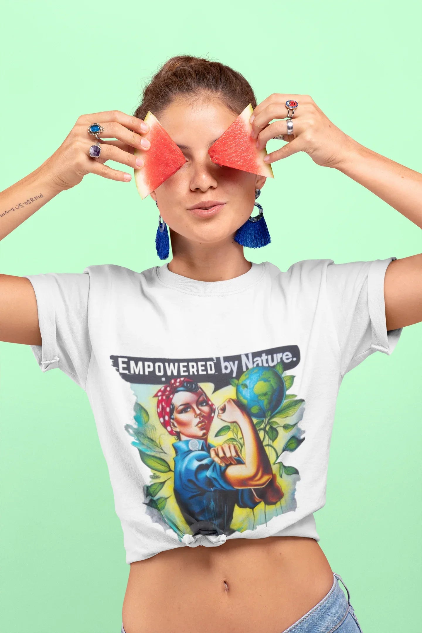 White graphic T-shirt worn by model, 'Empowered by Nature' slogan with nature art