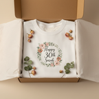 White birthday T-shirt with floral wreath 'Happy 30th Sarah' in open box.
