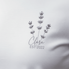 White t-shirt with lavender sprig graphic and “Chara” with EST/2022