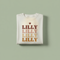 White name stack T-shirt with LILLY text graphic in stacked rows and heart