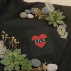 Black hoodie with red heart patch 'LILY' on the chest