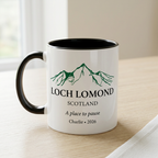 Loch Lomond mug with A place to pause and Charlie 2026 on a pale oak table