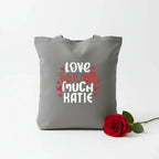 Grey tote bag with printed hearts and text: “LOVE YOU MUCH KATIE”