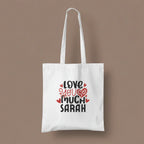 White tote bag with printed hearts and text: “LOVE YOU MUCH SARAH”