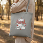 Light gray tote bag with 'LOVE YOU MUCH SOPHIE' heart text print.