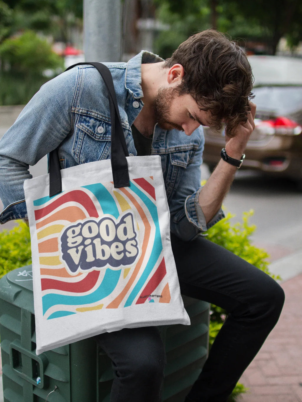 White tote bag with “good vibes” graphic and rainbow stripe design