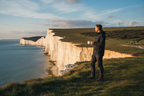 Man on Seven Sisters cliffs holding enamel mug