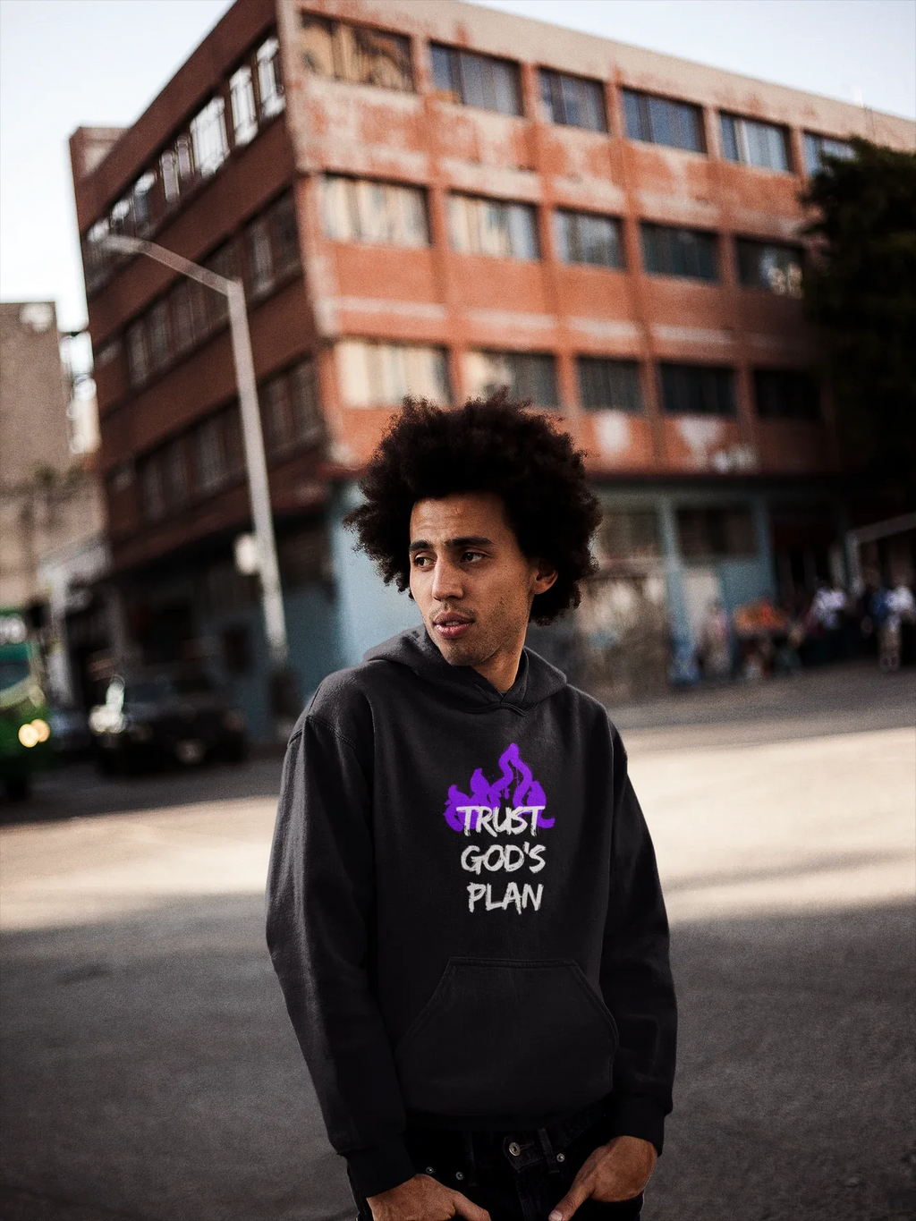 Black hoodie with hood down and purple flame-style text graphic on the chest.