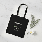 Black graduation tote bag with “THE GRADUATE” and green laurel, name Sophie