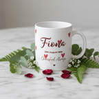 White ceramic heart-themed mug with red name 'Fiona' and date '29th August 1988'.