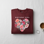 Maroon sweatshirt with “BIRTHDAY GIRL” text and colorful floral heart graphic