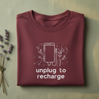 Unisex T-shirt in maroon with unplug to recharge phone graphic
