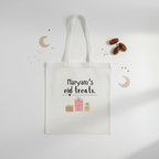 White cotton tote bag with handles and “Mariam’s eid treats” print with gift icons.