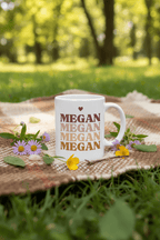 White ceramic mug with heart above stacked MEGAN text and side handle