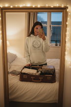 White couples hoodie worn by person, featuring 'Still waiting on the honeymoon' wreath print