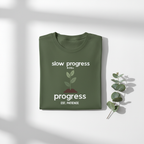 Military green T-shirt with "slow progress" slogan and minimal plant graphic, crew neck.