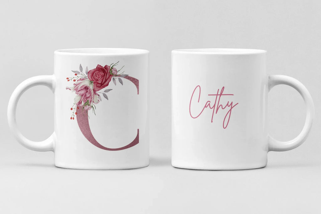 Pair of white ceramic mugs: floral letter C and pink cursive name Cathy.