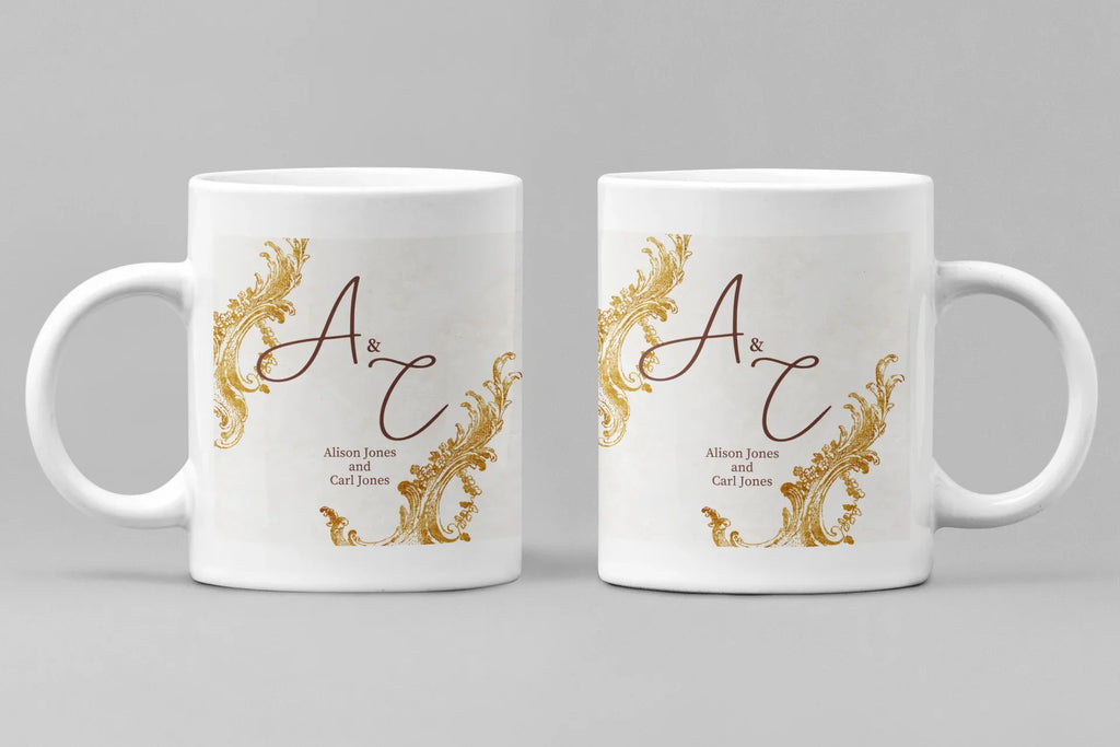 Pair of white mugs with gold filigree and dark red monogram design