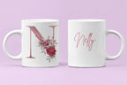Pair of white ceramic mugs: floral letter N and pink cursive name Nelly.