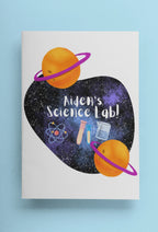Science-themed journal cover with purple heart, orange planets, and “Alien’s Science Lab!”