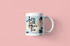 White tea mug with 'Less Talk, More Tea' graphic and stone design on pink