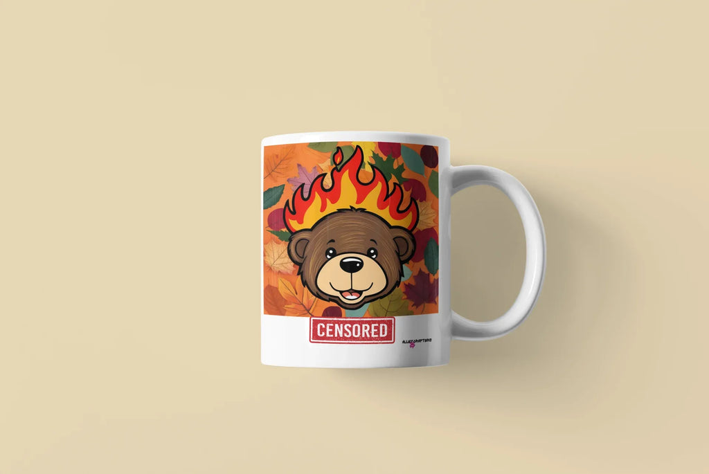 White ceramic bear mug with flames graphic and red “CENSORED” label, side view.
