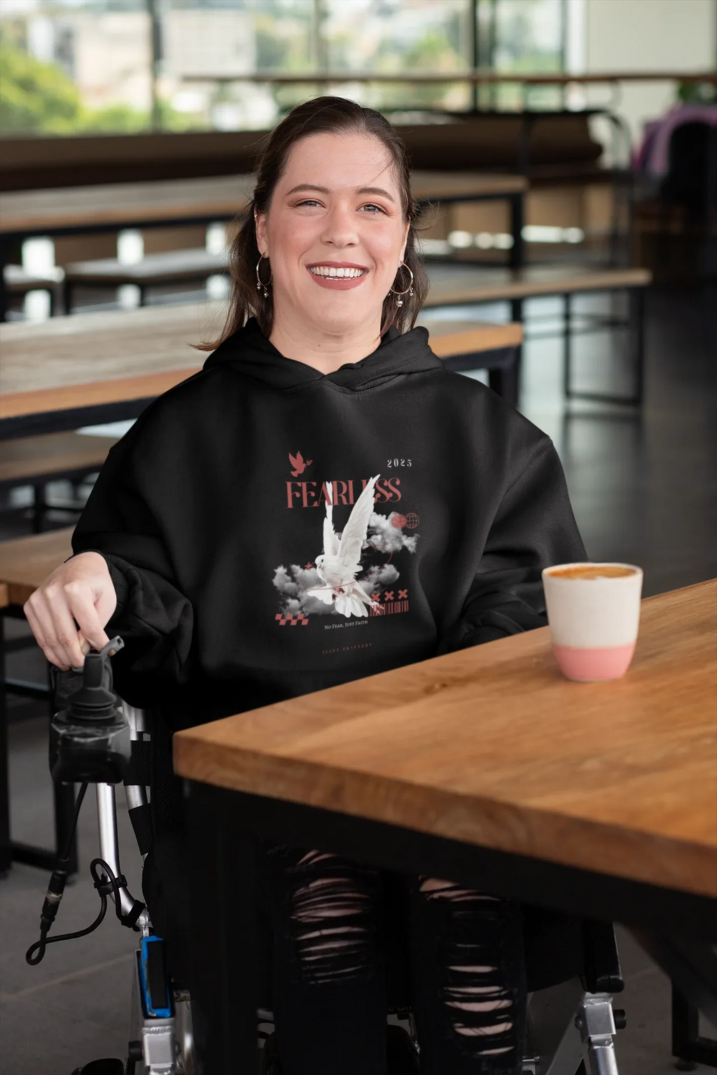 Black unisex hoodie with hood and front graphic, front pocket visible