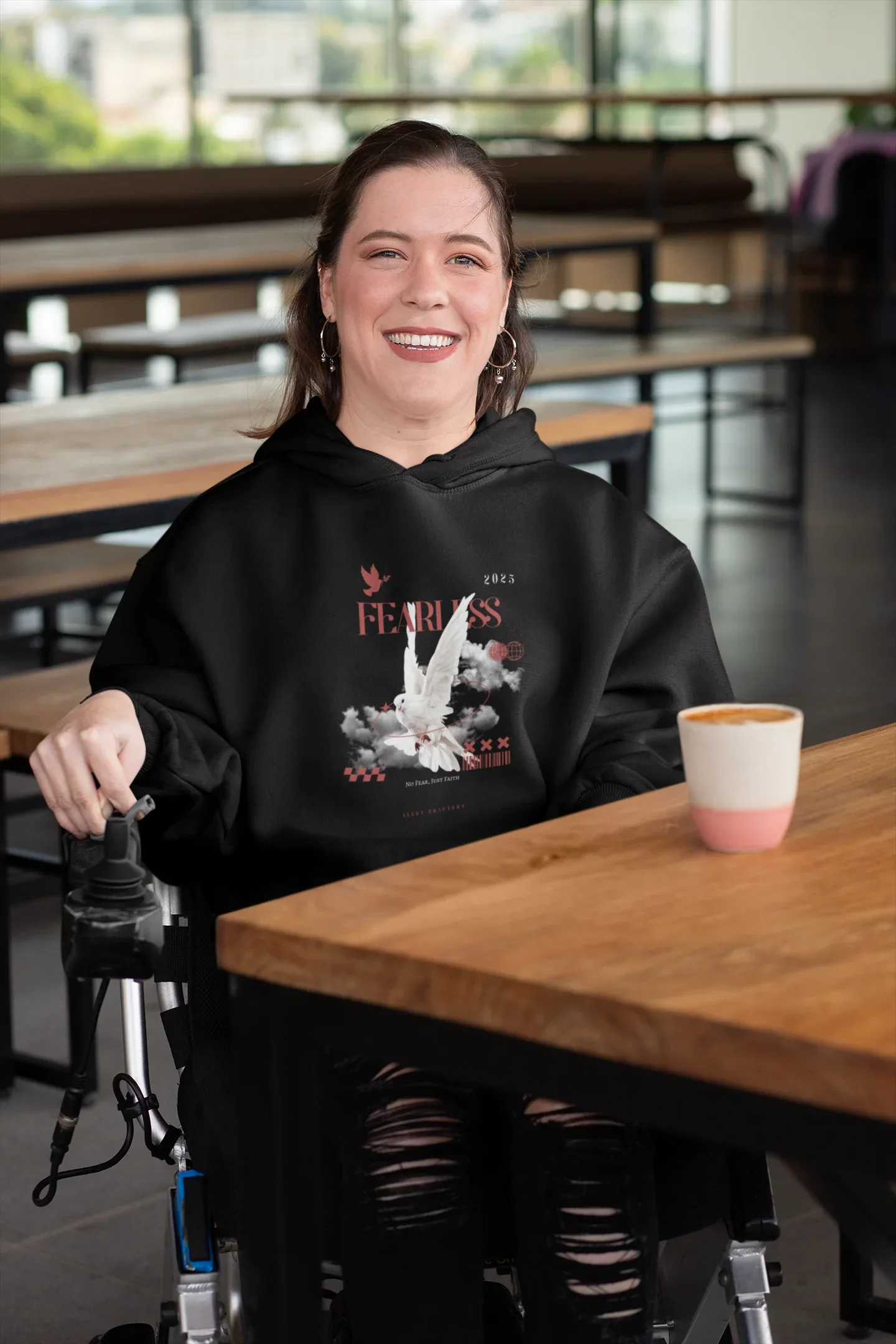 Black unisex hoodie with hood and front graphic, front pocket visible