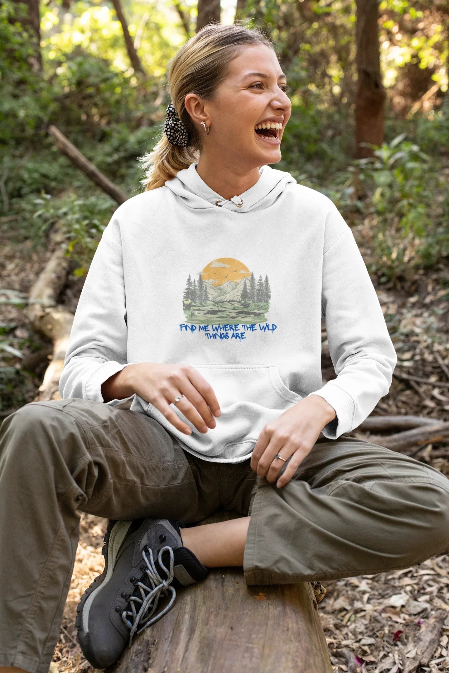 White hoodie on model, front view with mountain forest graphic and blue text