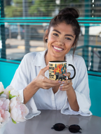 Ceramic tea mug with flaming cat graphic and black handle