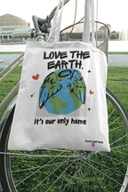 White tote bag with Earth graphic and text Love the Earth, it’s our only home