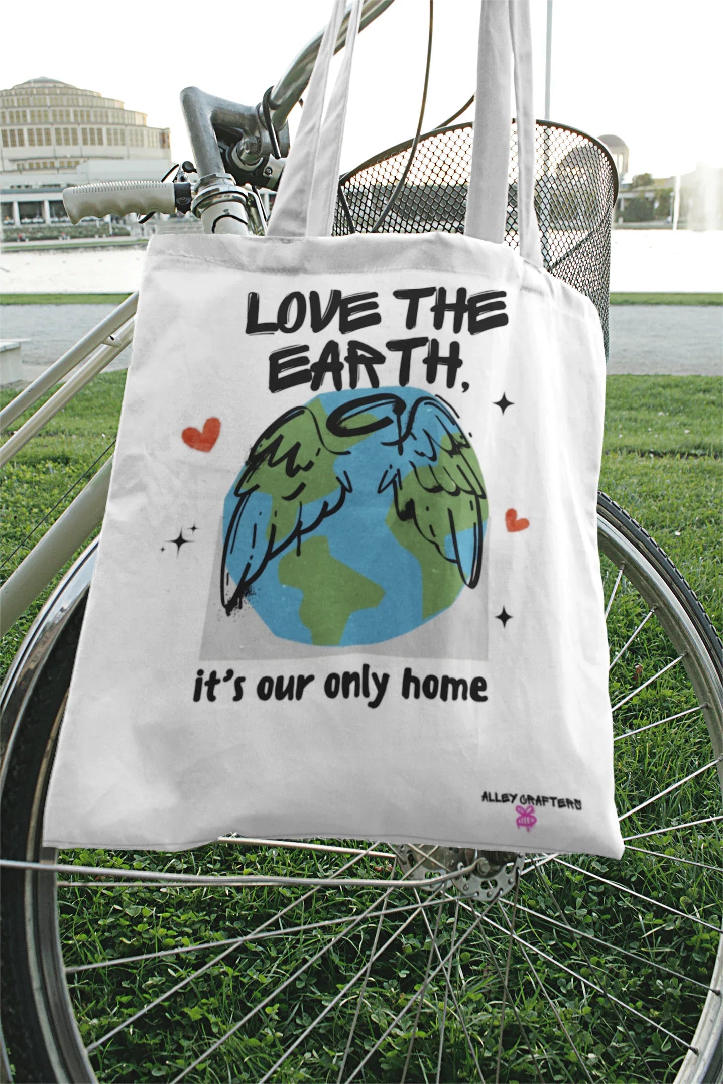 White tote bag with Earth graphic and text Love the Earth, it’s our only home