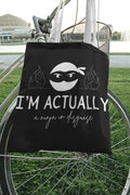 Black tote bag with ninja face graphic, 'I'M ACTUALLY', and 'a ninja in disguise'.