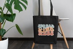 Black cotton tote bag with 'SPREAD KINDNESS' graphic, front view