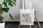 White canvas tote bag with long handles, centered front quote graphic in colorful ink