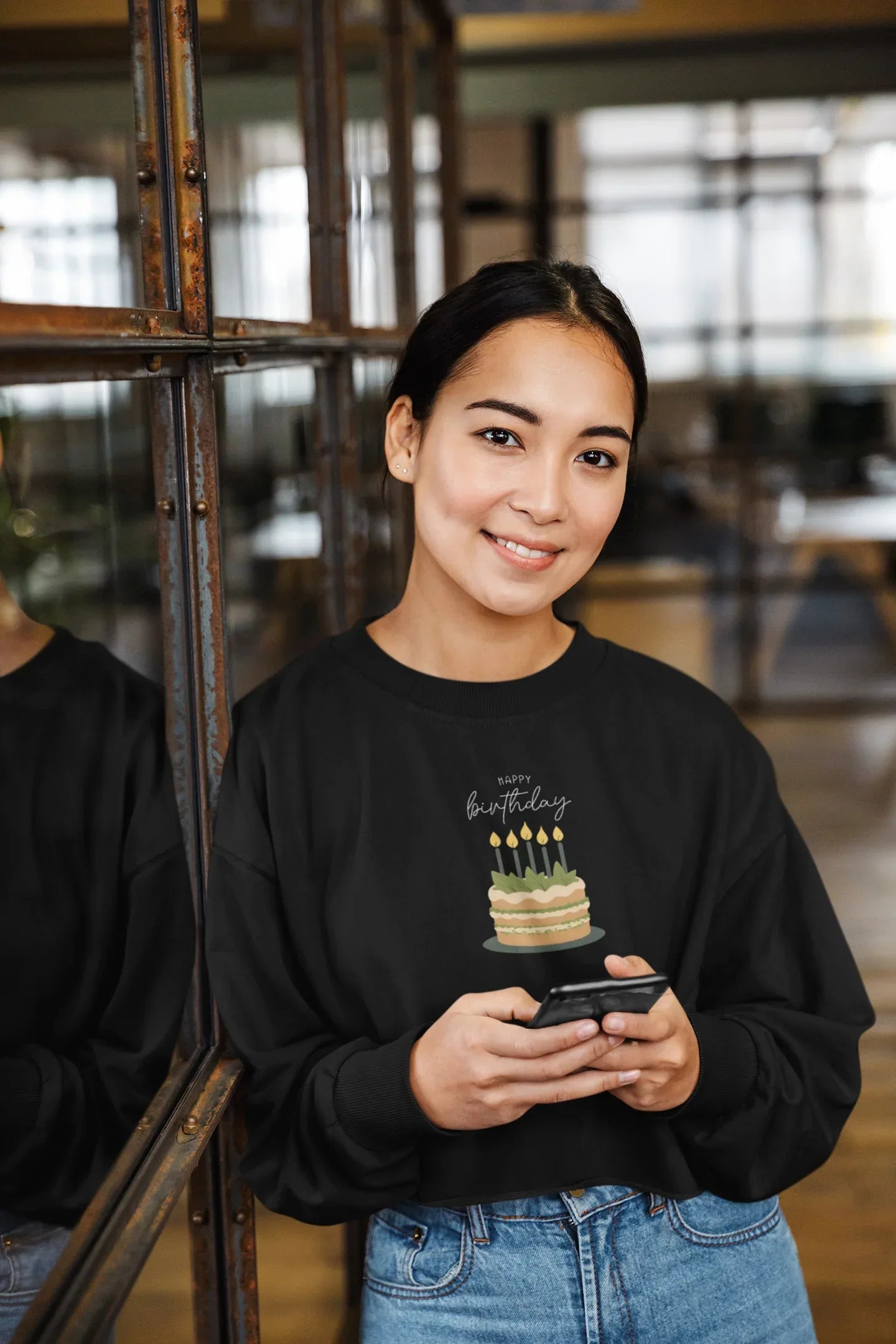 Black crewneck sweatshirt with “Happy birthday” cake and candle graphic