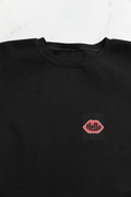 Black sweatshirt with embroidered lip logo on the left chest.
