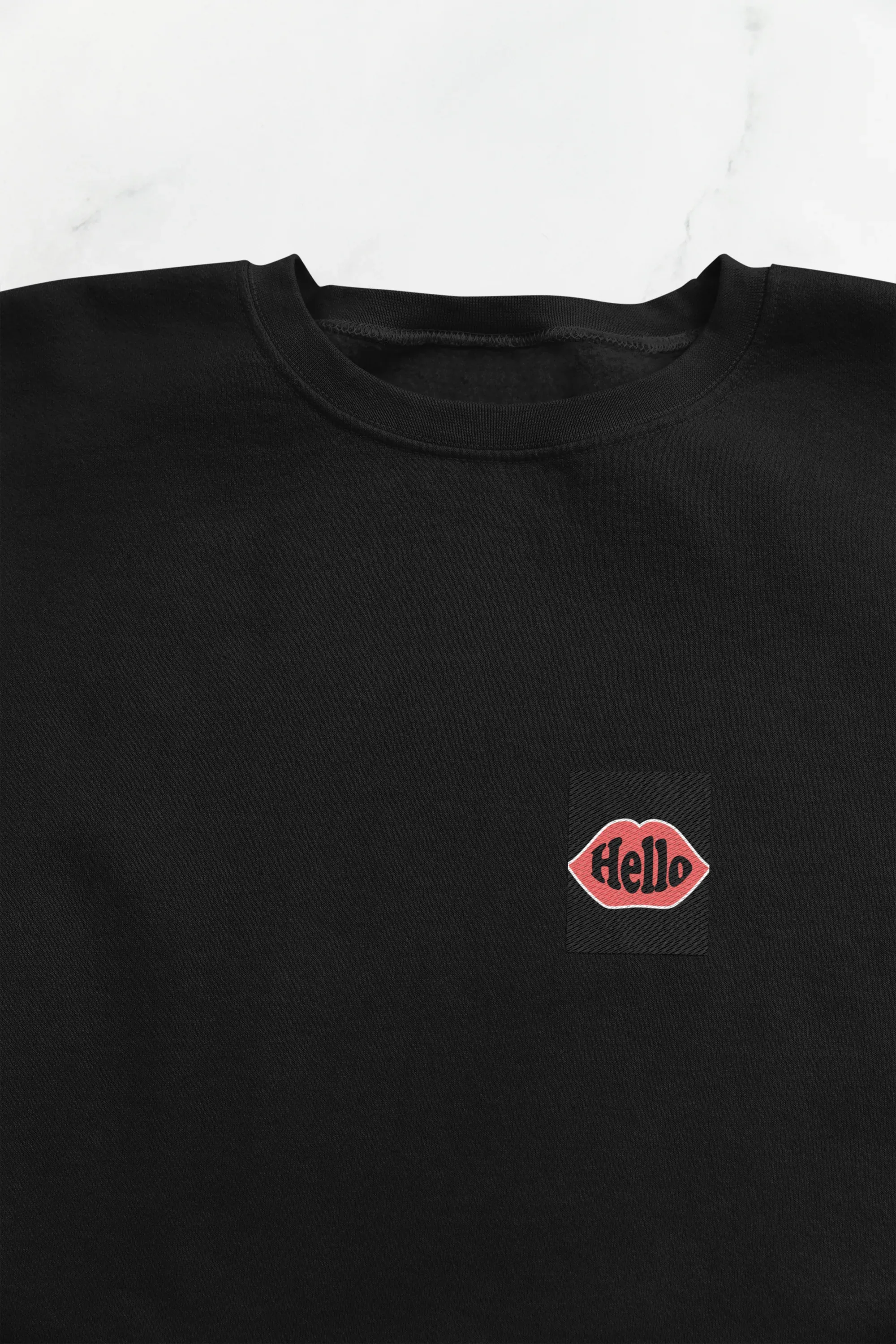 Black sweatshirt with embroidered lip logo on the left chest.