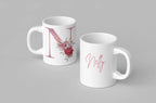 White ceramic mug with floral letter I design on one side and blank handle.